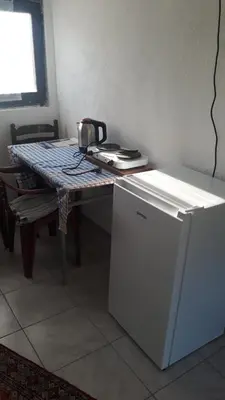 a table with a refrigerator next to a table with at Piramida Mjeseca in Visoko