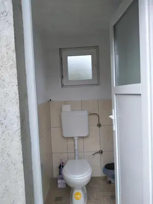 a small bathroom with a toilet with a window at Piramida Mjeseca in Visoko