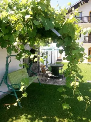 a garden with a table and chairs and a bench at Holiday Home Nana in Bugojno