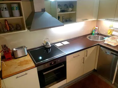 a kitchen with a sink and a stove top oven at Natural Cottage Una in Bihać