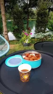 a table with a bowl of food and a cup of coffee at Natural Cottage Una in Bihać