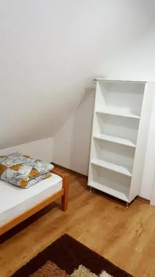 a bedroom with a bed and a book shelf at Natural Cottage Una in Bihać
