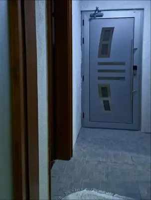 a door with a sign on it next to a hallway at Apartment Sekulic in Doboj