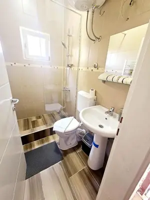 a small bathroom with a toilet and a sink at AMAI Exclusive in Tuzla
