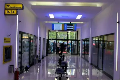 an empty hallway of a building with people walking through it at AMAI Exclusive in Tuzla