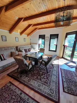 a living room with a couch and a table at Kuća za odmor Panorama Lohovo Bihać in Bihać