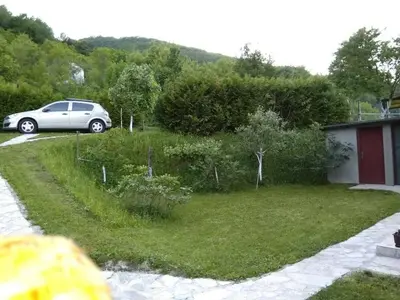 a car parked in the yard of a house at Kuća za odmor Panorama Lohovo Bihać in Bihać