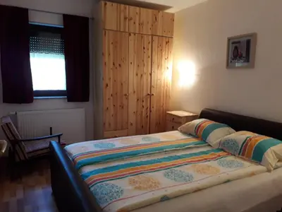 a bedroom with a bed and a wooden cabinet at Kuća za odmor Panorama Lohovo Bihać in Bihać