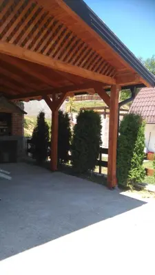 a wooden pergola with some bushes and a fence at Kuća za odmor Panorama Lohovo Bihać in Bihać