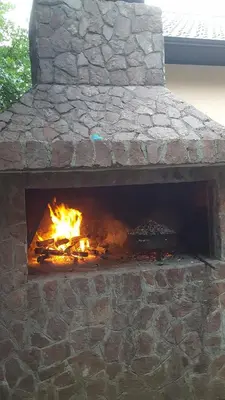 a brick oven with a fire in it at Holiday Home Adna in Bihać