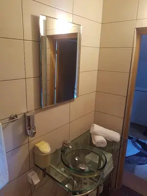 a bathroom with a glass sink and a mirror at Holiday Home Adna in Bihać