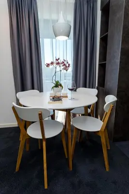 a white table and chairs with a glass of wine at Konak na Uni in Bihać