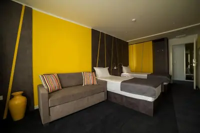 a hotel room with two beds and a couch at Konak na Uni in Bihać