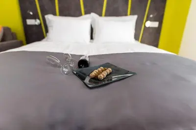 a plate of food on a bed with a pair of scissors at Konak na Uni in Bihać