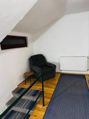a living room with a black couch and a table at Rooms Cobras II in Jajce