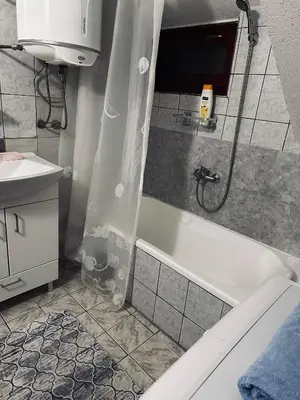 a bathroom with a shower and a tub and a sink at Rooms Cobras II in Jajce
