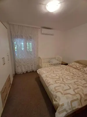 a bedroom with a large bed and a window at Apartments Lela in Bihać