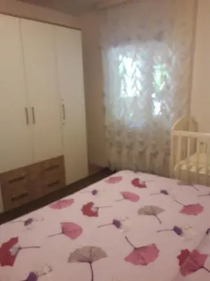 a bedroom with a bed with a bedspread with umbrellas at Apartments Lela in Bihać