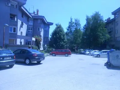 a parking lot with many cars parked in it at Apartments Lela in Bihać