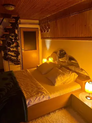 a bed in a room with two lights on it at Holiday Home Dzejla in Vlasic
