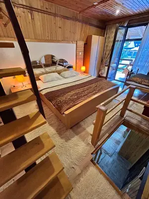 a bedroom with a bed and a staircase in it at Holiday Home Dzejla in Vlasic