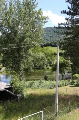a street light on a pole next to a river at Apartment Prole in Šipovo