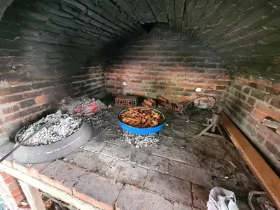 a brick oven with a bunch of food in it at Apartment Prole in Šipovo