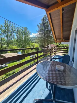 a patio with a table and chairs on a balcony at Apartment Prole in Šipovo