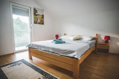 a bedroom with a bed and a large window at Villa La Unica in Lohovo