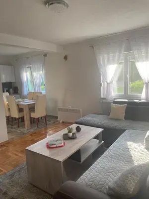 a living room with a couch and a table at Villa La Unica in Lohovo