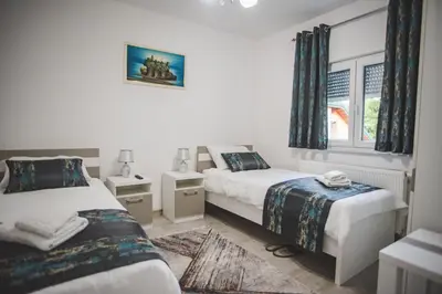 a bedroom with two beds and a window at Villa La Unica in Lohovo