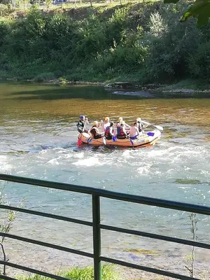 a group of people in a raft on a river at Holiday Homer Vila na Obali Vrbasa in Banja Luka