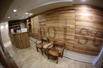 a room with two chairs and a wall with writing on it at Hotel Blanca Resort & Spa in Vlasic