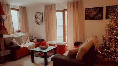 a living room with a christmas tree and a couch at Apartments K.I.D.S. in Vlasic