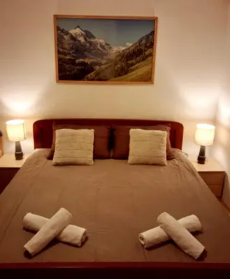a bedroom with a bed with two towels on it at Apartments K.I.D.S. in Vlasic