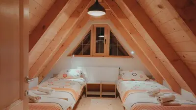 a room with three beds in a attic at Apartments K.I.D.S. in Vlasic