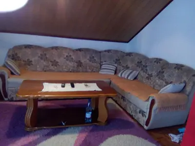 a couch in a living room with a coffee table at Apartman Ela in Bihać