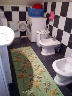 a bathroom with two toilets and a sink at Apartman Ela in Bihać