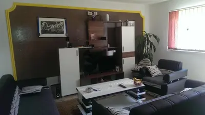 a living room with a couch and a tv at Apartman Ela in Bihać
