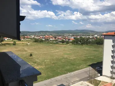 a view of a field and a city from a building at Apartment Nesrine in Bihać