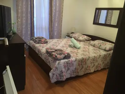 a small bedroom with a bed and a television at Apartment Nesrine in Bihać