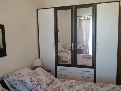 a bedroom with a bed and a large mirror at Apartment Nesrine in Bihać