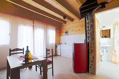 a kitchen with a table and a red refrigerator at Holiday homes Piralo in Kostajnica