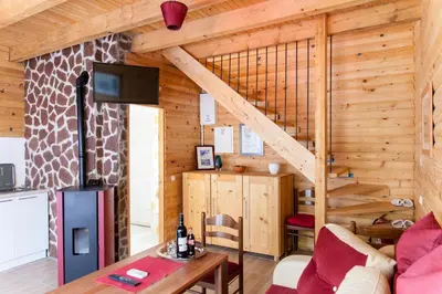 a living room with a staircase in a log cabin at Holiday homes Piralo in Kostajnica