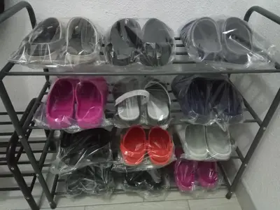 a shelf with four pairs of shoes on it at Apartments Žera in Vlasic