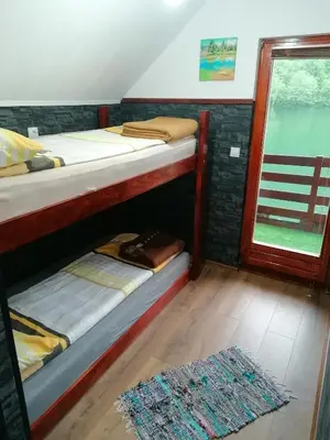 two bunk beds in a room with a window at Jajce,Plivsko jezero in Jajce