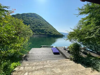 a dock on a lake with a boat on it at Jajce,Plivsko jezero in Jajce