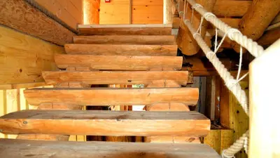 a group of wooden stairs in a cabin at Guest House Mala Prica in Živinice