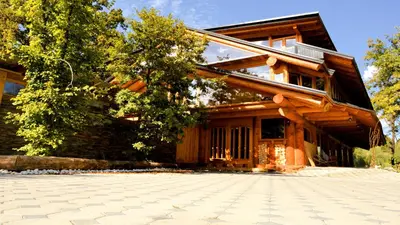 a house with a stone driveway in front of it at Guest House Mala Prica in Živinice