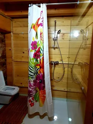 a shower curtain in a bathroom with a toilet at Guest House Mala Prica in Živinice